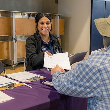 person handing out paperwork